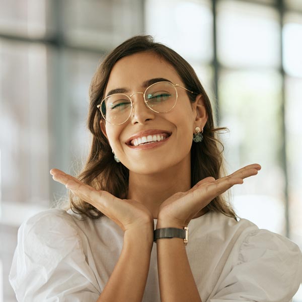 smiling person framing face with hands